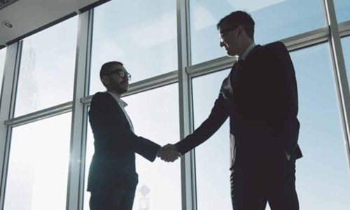 Businessmen are Shaking Hands with each other — Commercial Conveyancing in Wyong NSW