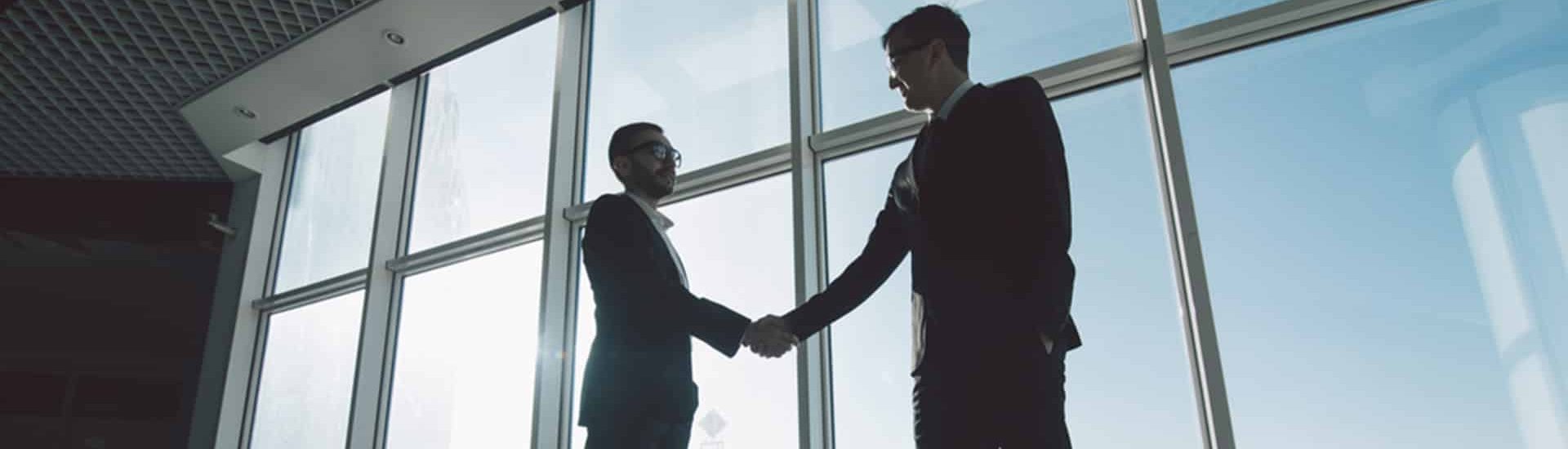 Businessmen are Shaking Hands with each other — Commercial Conveyancing in Wyong NSW